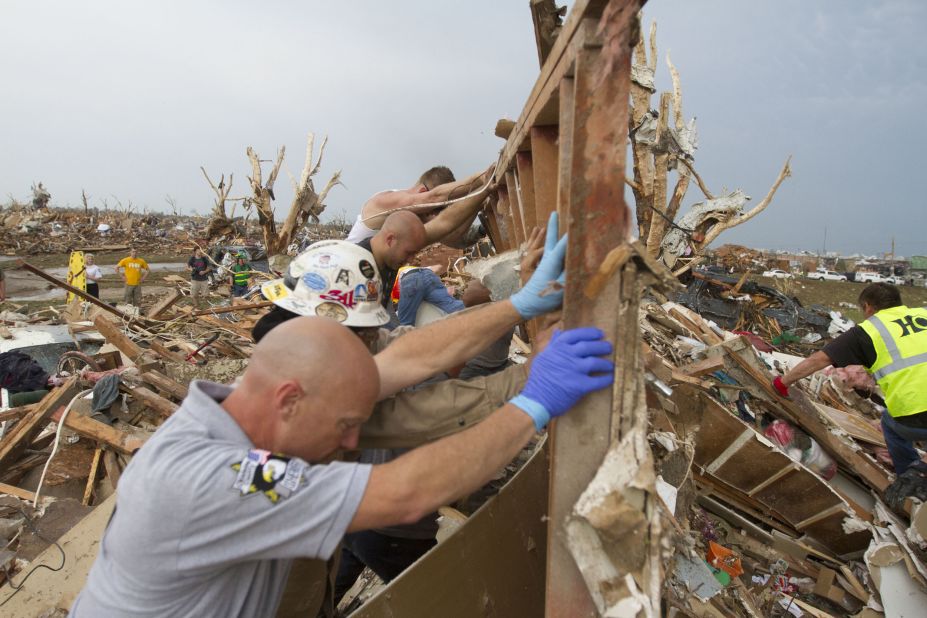Rescuers dig out a house in Moore on May 21. 