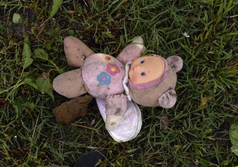 A doll covered in dirt is among the rubble scattered throughout a neighborhood in Moore on May 21.