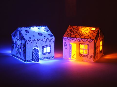 Bare Conductive's House Kit contains two paper houses, wired with conductive paint, which light up in the dark.