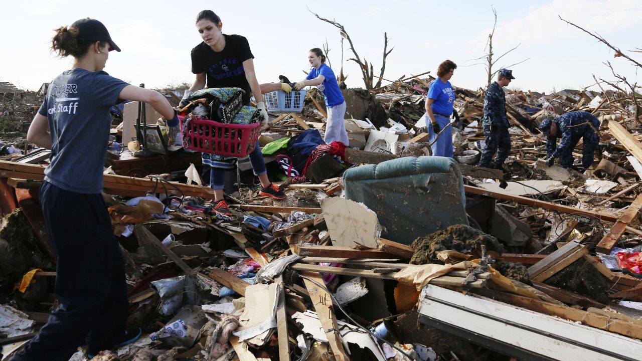 Volunteers form a chain to retrieve clothing and other household items on May 22.