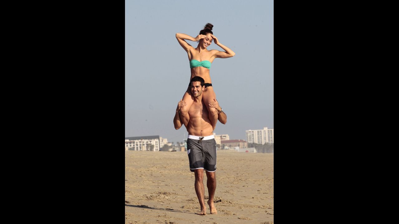 "Dallas" actor Jesse Metcalfe gave his fiancee, Cara Santana, a lift at the beach in Santa Monica, California, in April 2013.