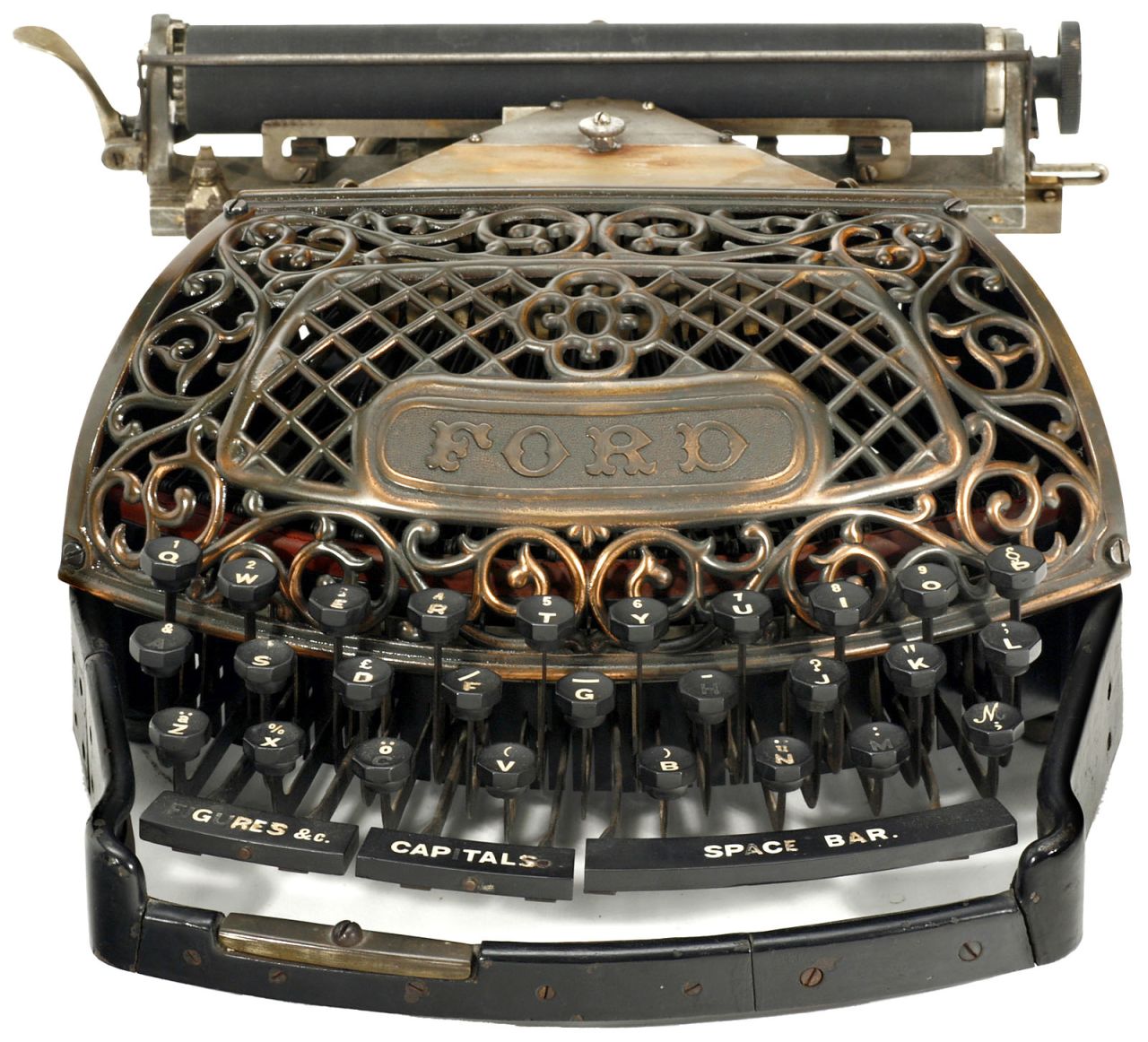 An 1895 Ford typewriter with filigree copper grille. The invention of typewriters in the mid 19th century changed the face of professional writing. The QWERTY keyboard is still the most common modern-day keyboard layout.