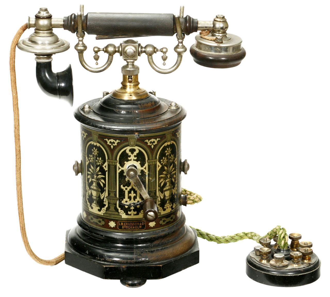 A 1905 L.M. Ericsson & Co. desk telephone known as the 'coffee grinder' for its circular shape and distinctive lithographed decoration.
