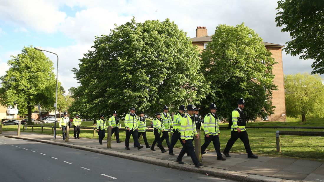 Police walk to the scene in Woolwich on May 22.