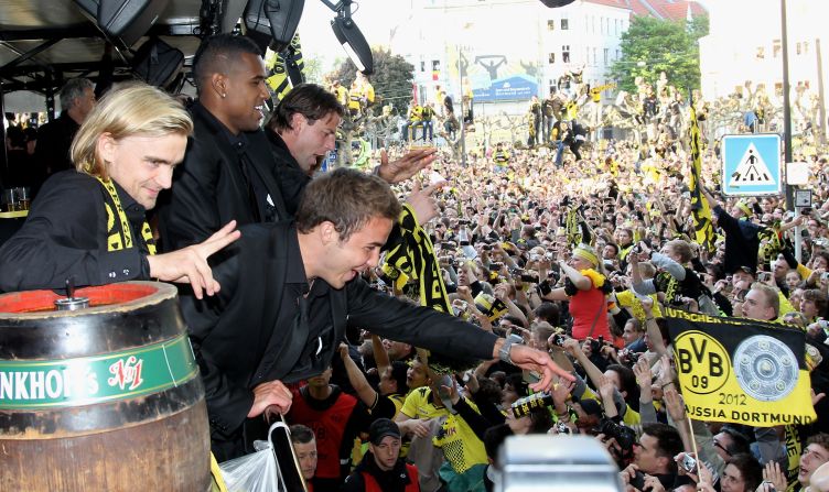 Gotze celebrates with colleagues and fans as Dortmund celebrate their 2012 league and cup double.