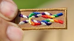  A member of Scouts for Equality holds an unofficial knot patch incorportating the colors of the rainbow, a symbol for gay rights.