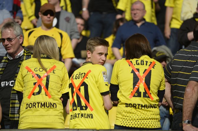 Dortmund fans wear replica jerseys of midfielder Mario Goetze with a X though them following his controversial transfer to bitter Bundesliga rivals Bayern Munich. 