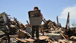Heather Shannon helps a friend find family photos and other keepsakes at her home in Moore, Oklahoma, on May 22. People who lost their homes to the tornado on Monday continue to search through the rubble in hopes of finding some of their belongings.