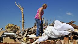 Kelcy Trowbridge searches for family keepsakes in the rubble of her home.