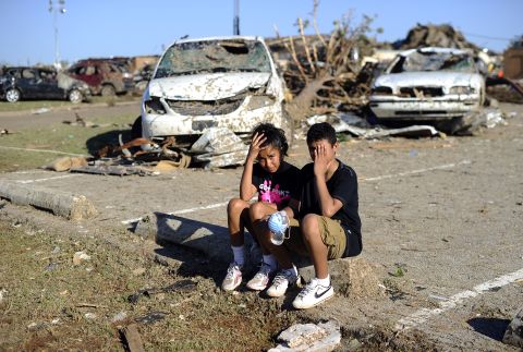 Plaza Towers Elementary School students Monica Boyd and Lavontey Rodriguez sit at the parking lot of their tornado devastated school.