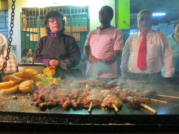 Chef Coque Ossio took Anthony Bourdain and Eric Ripert to one of his favorite street stalls in Lima for Anticuchos: grilled beef heart usually marinated in aji panca, cumin, vinegar, onions and oil.