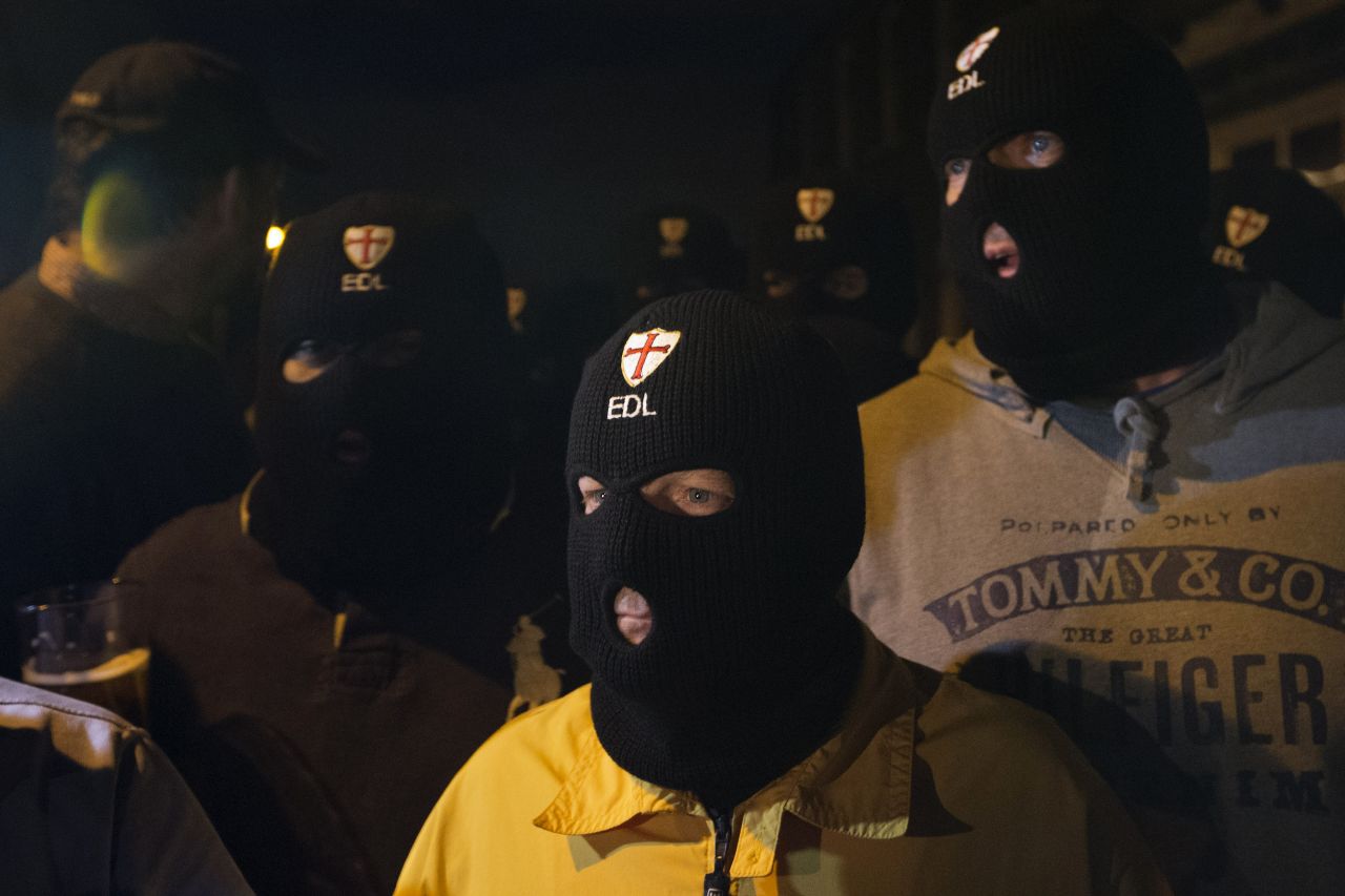 Members of the far-right English Defence League wear balaclavas as they gather outside a pub in Woolwich on Wednesday, May 22.