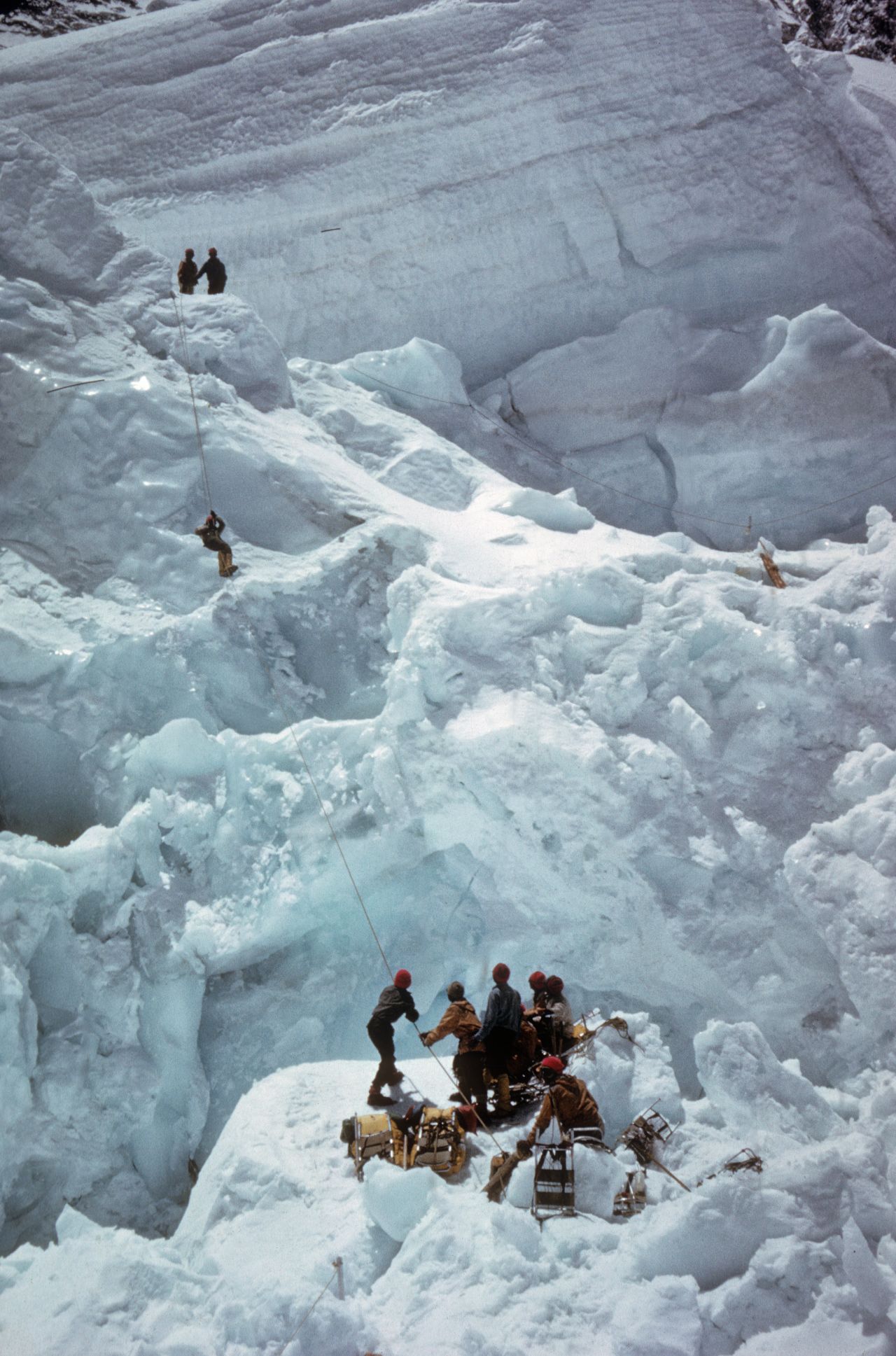 Climbers work their way through the dangerous Khumbu Icefall, a shedding glacier just after Everest base camp.