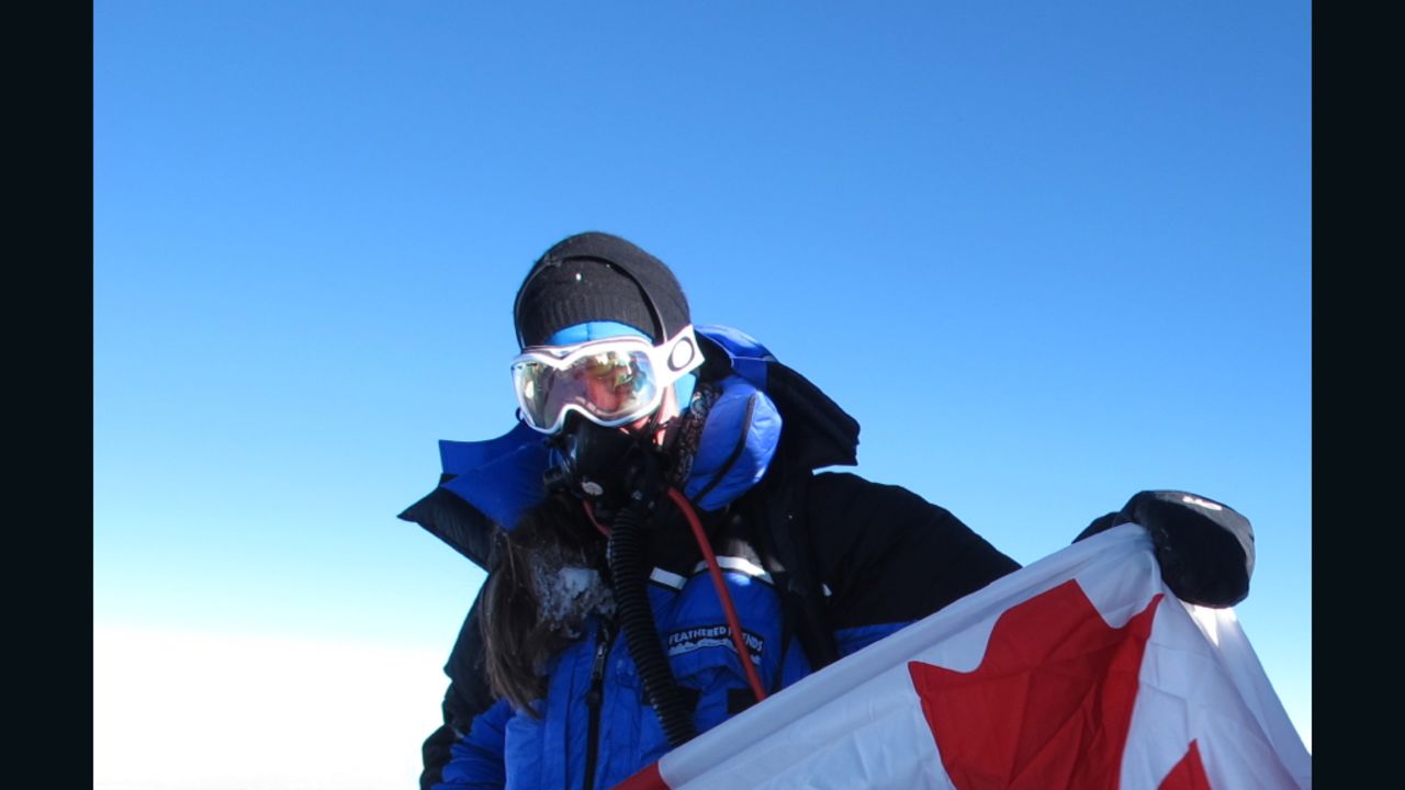 Sandra LeDuc on the summit, holding the Canadian flag.