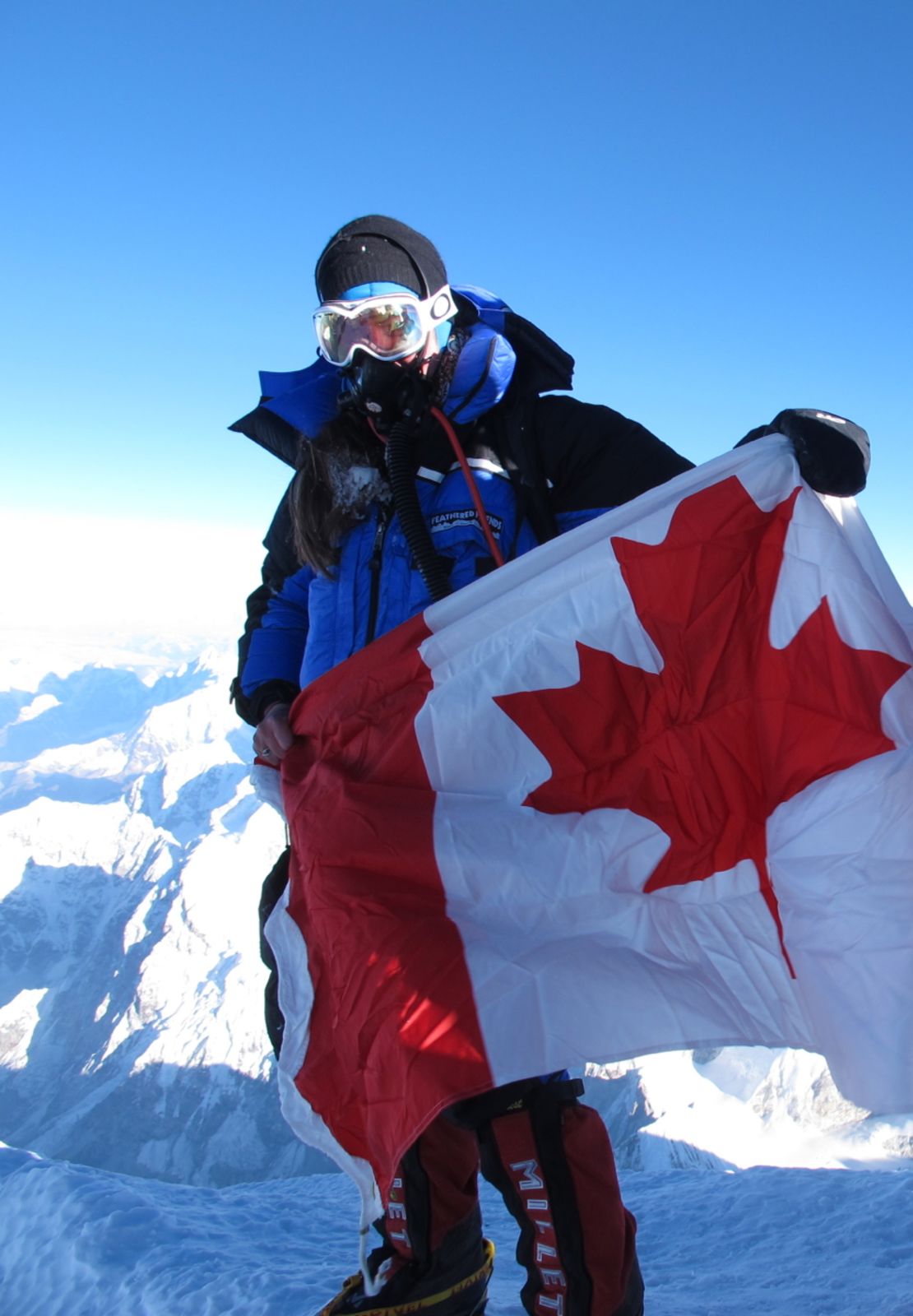 Sandra LeDuc on the summit, holding the Canadian flag.