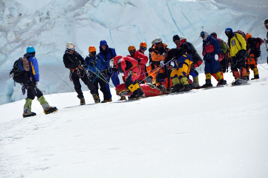 Climbers on Everest work to help someone in distress.