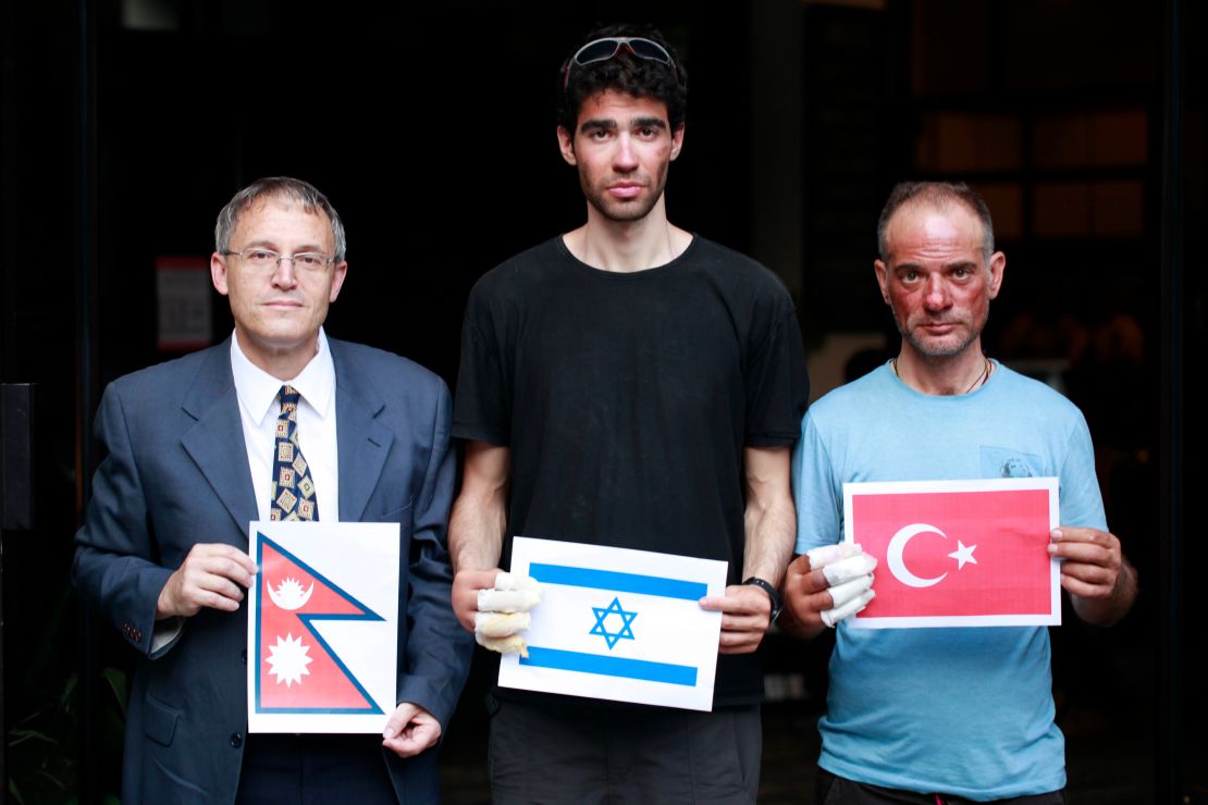 Nadav Ben Yehuda (center) and Aydin Irmak (rightt) with Israeli ambassador to Nepal, Hanan Goder-Goldberger -- all holding their respective flags.