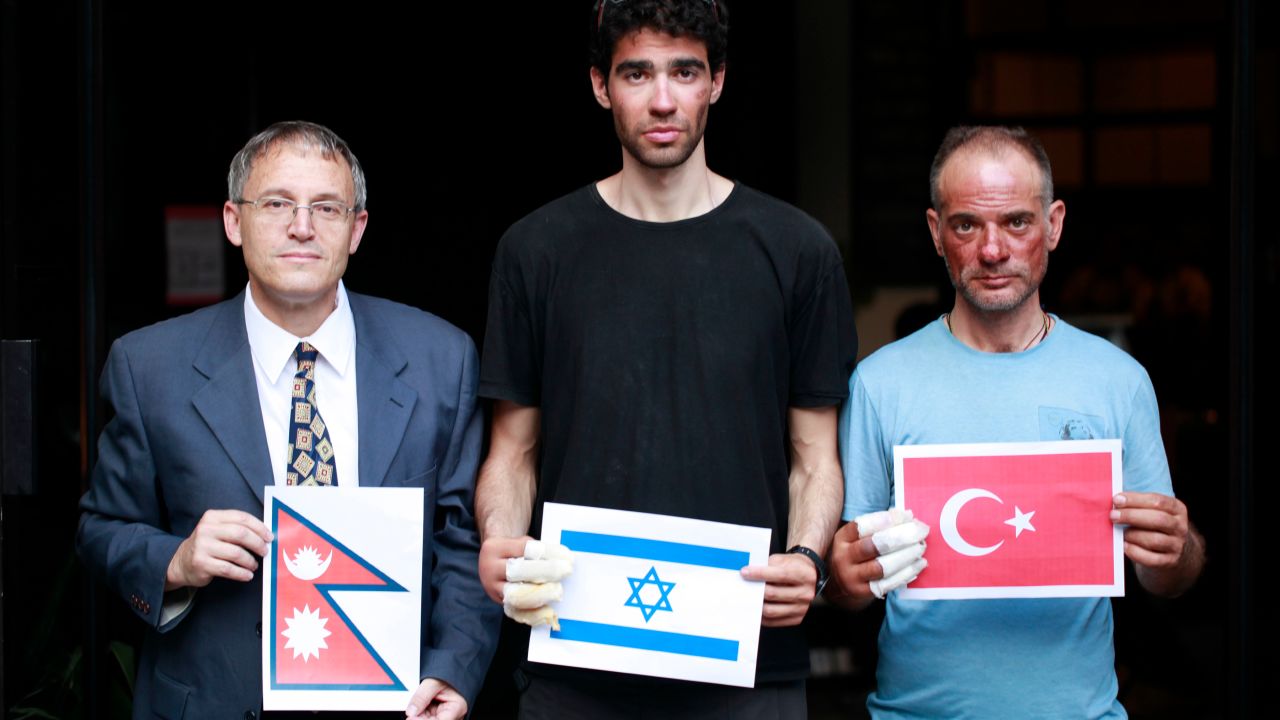 Nadav Ben Yehuda (center) and Aydin Irmak (rightt) with Israeli ambassador to Nepal, Hanan Goder-Goldberger -- all holding their respective flags.