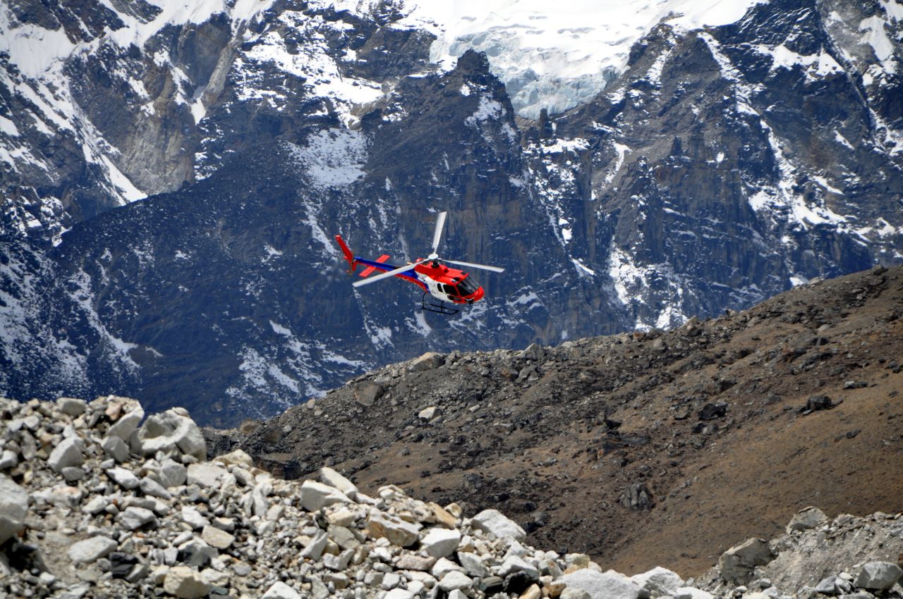A helicopter flies into base camp. Rescue helicopters can't fly above Camp 2 on Everest to reach stranded climbers.