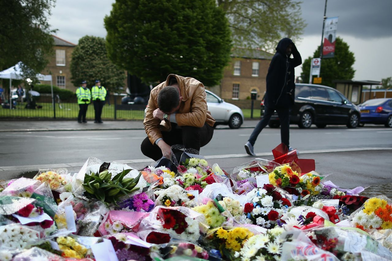 A man contemplates the makeshift memorial outside Woolwich Barracks in London.