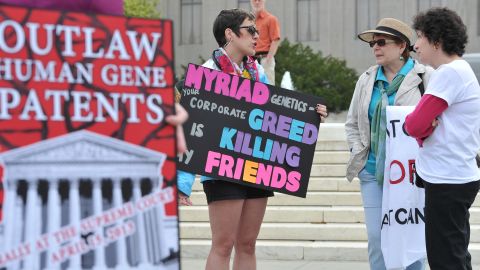  Protesters hold banners outside the Supreme Court on April 15, demanding a ban on human gene patents.   
