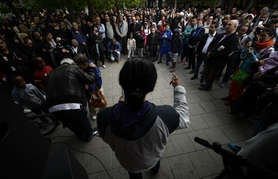 People attend a demonstration against police violence and vandalism in the Stockholm suburb of Husby on Wednesday, May 22.