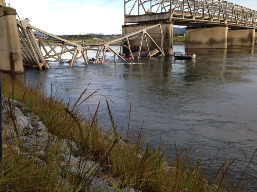 People examine the collapsed section of the bridge in this photo shot by iReporter Adrian Adrande.