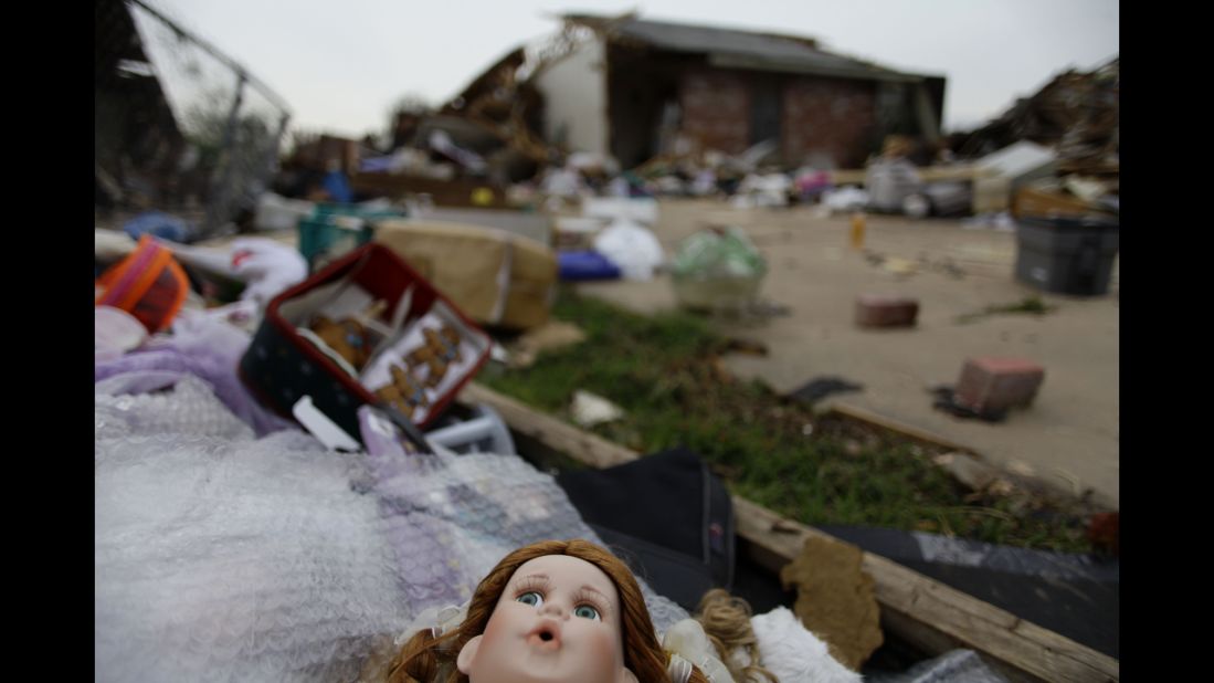 Debris is scattered across a driveway on May 23. Severe thunderstorms barreled through this Oklahoma City suburb at dawn Thursday, complicating cleanup efforts.