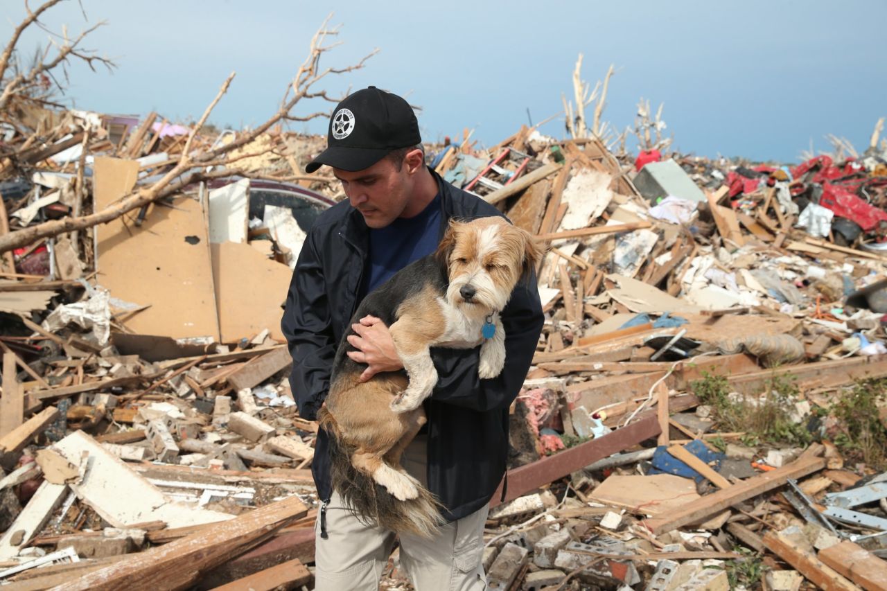 Sean Xuereb recovers a dog from the rubble of a home that was destroyed by the massive tornado that hit Moore, Oklahoma, on Monday, May 20. A website has been set up to help <a href="http://www.okclostpets.com" target="_blank" target="_blank">lost and found pets</a>, and shelters have been set up to help displaced and injured animals. For ways to help, visit <a href="http://www.cnn.com/SPECIALS/impact.your.world/">CNN.com/impact.</a>