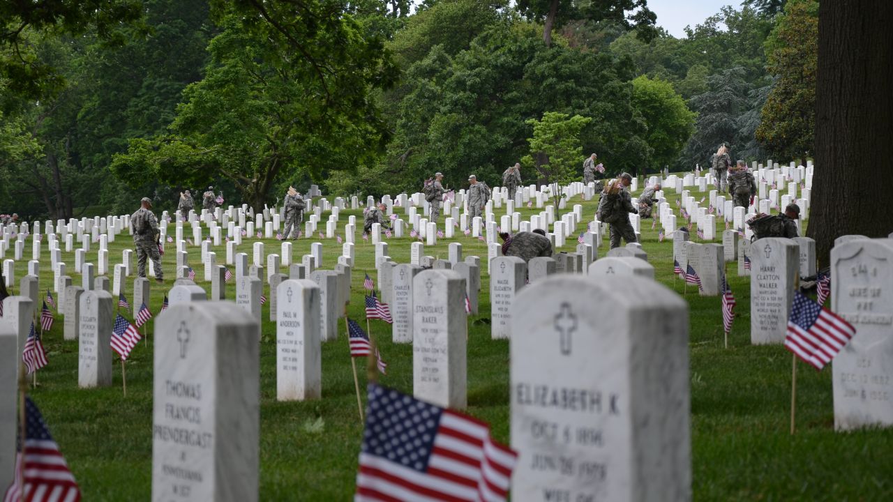 Members of the Army's 3rd Infantry Regiment -- also known as the "Old Guard" -- plant flags at tombstones in Arlington National Cemetery in Washington on Thursday, May 23, ahead of Memorial Day. Washington is a city of war memorials.