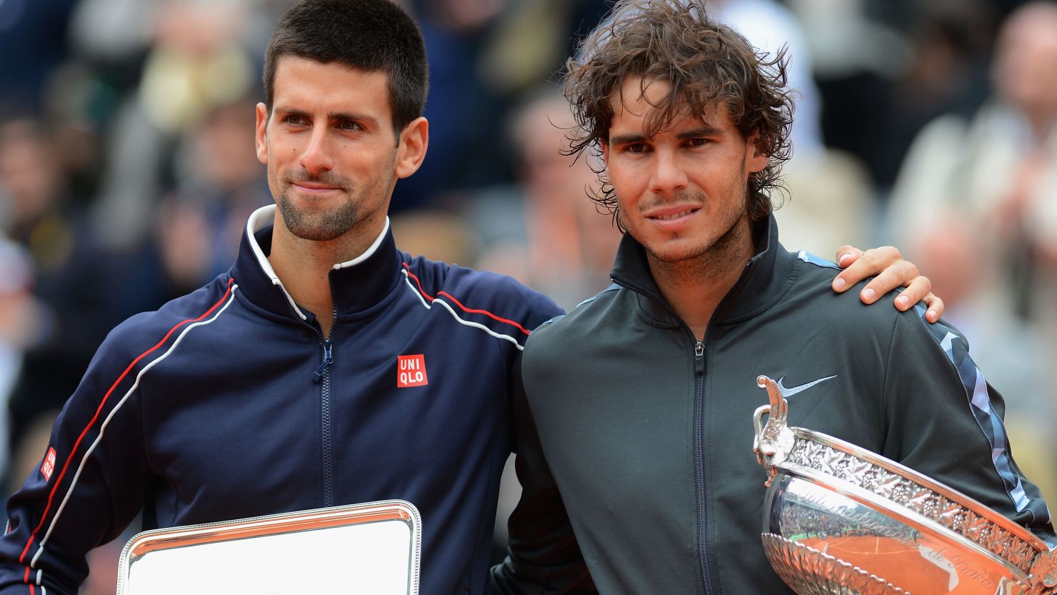 Rafael Nadal celebrates his French Open title success in 2012 with runner-up Novak Djokovic.