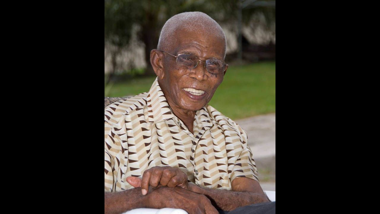 James Sisnett was born February 22, 1900, in Barbados. He made it to 113 and believed he lived that long by eating good food; having a daily "little one," his name for an alcoholic drink; and "God's grace." He worked as a blacksmith, a sugar factory worker and a farmer before retiring at age 70. His longevity made him a local celebrity. His only real health challenge toward the end of his life was hearing loss. He died in May 2013.