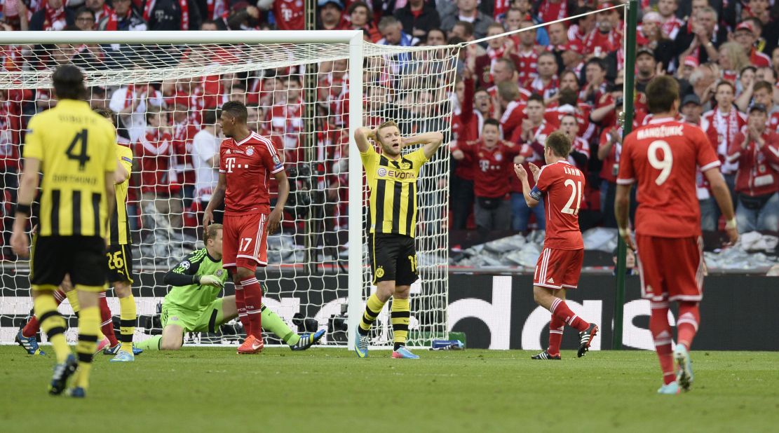 Borussia Dortmund's Polish midfielder Jakub Blaszczykowski, center, reacts after missing a goal against Dortmund.