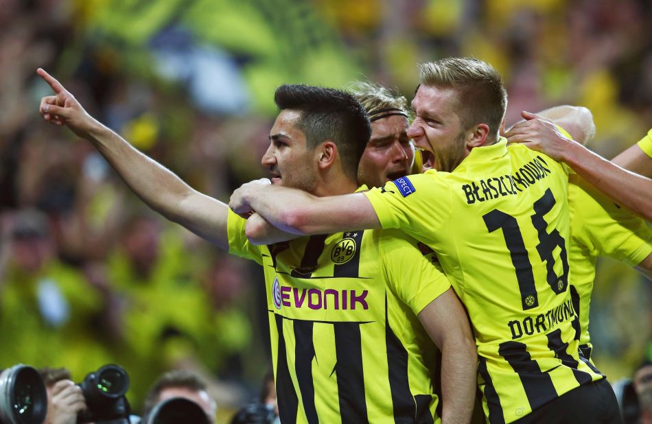 Ilkay Gundogan of Borussia Dortmund, left, celebrates with teammates after scoring on a penalty kick to tie the game 1-1.