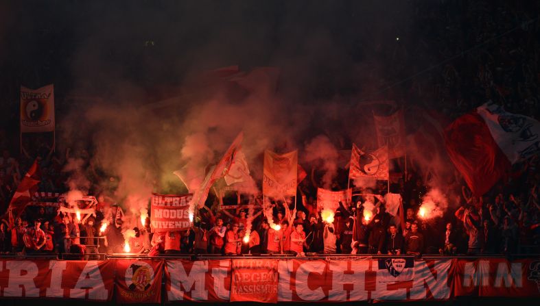 Bayern Munich supporters light flares in the stands during the game.