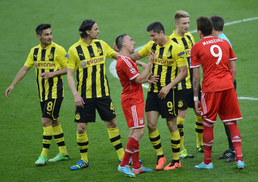 Bayern Munich's French midfielder Franck Ribery, center, talks with Borussia Dortmund's striker Robert Lewandowski after a penalty was called.