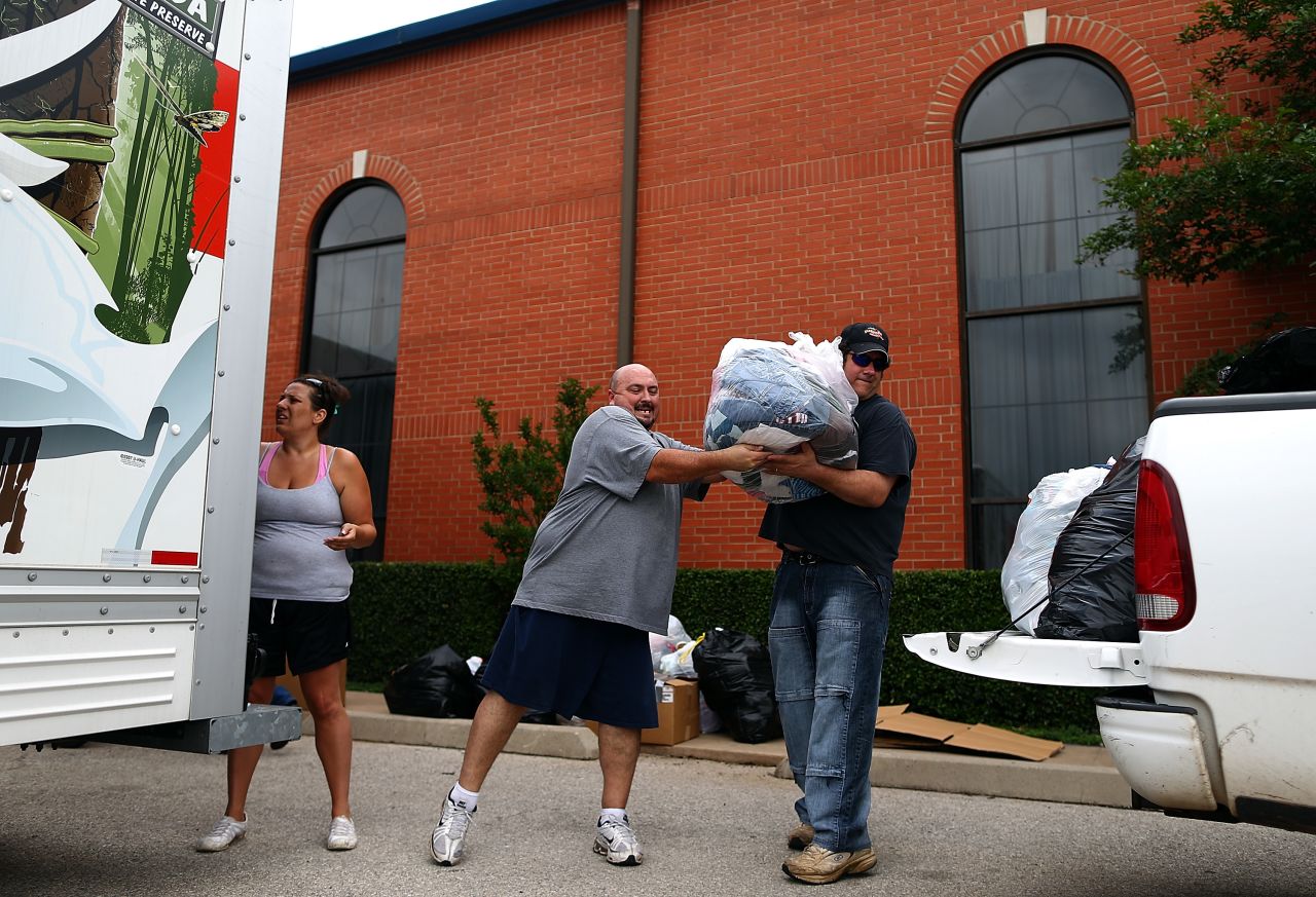 Volunteers unload donated items for tornado victims at the Yellow Rose Theater on May 25 in Moore.