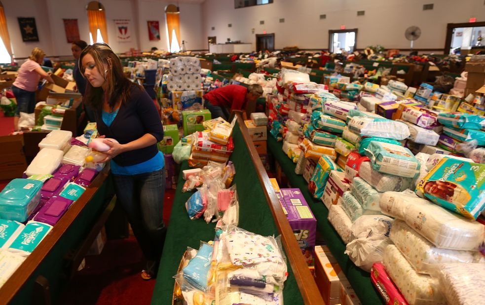 Volunteer Brittany Pendergraft organizes donated tornado relief items inside the Yellow Rose Theater on May 25 in Moore.