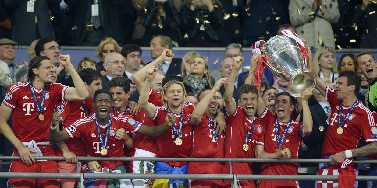 Bayern Munich players lift the trophy as they celebrate winning the UEFA Champions League final after beating Borussia Dortmund 2-1 at Wembley Stadium in London on Saturday, May 25.