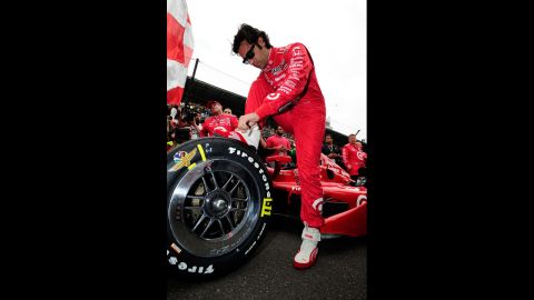 Dario Franchitti of Scotland makes adjustments to his car before the start.