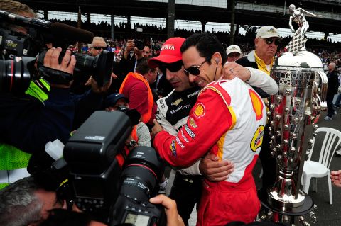 Tony Kanaan, left, and Hélio Castroneves of Brazil greet each other.