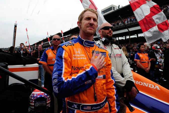 Driver Charlie Kimball stands on the grid during the performance of the national anthem.