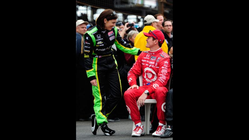 Katherine Legge of England, left, and Scott Dixon of New Zealand talk before the start of the race.