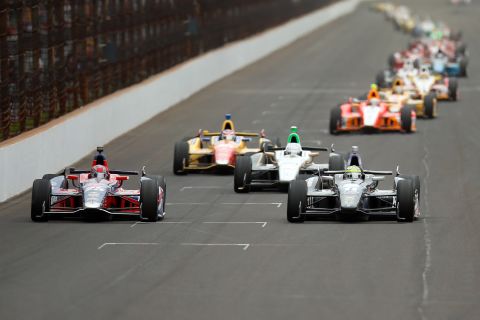 Marco Andretti in No. 25 for Andretti Autosport, left, and Tony Kanaan of Brazil in No. 11 lead the pack before a turn.