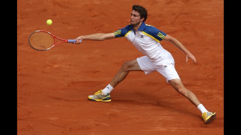 Gilles Simon of France reaches to make a forehand return against Lleyton Hewitt of Australia on May 26. Simon won  3-6, 1-6, 6-4, 6-1, 7-5.