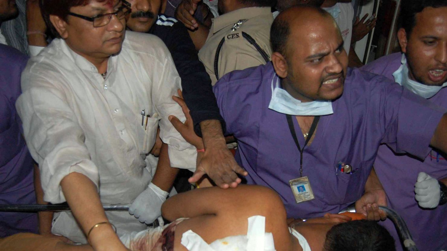 Indian medical staff carry an injured victim early May 26 after an ambush on a convoy of Congress Party leaders in Chhattisgarh. 