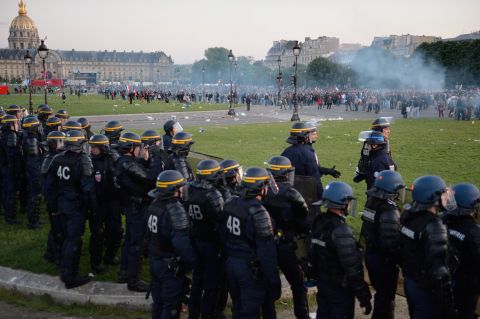 Riot police stand in a line facing protesters on May 26.