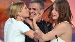 French actress Lea Seydoux kisses French-Tunisian director Abdellatif Kechiche as actress Adele Exarchopoulos watches after he was awarded with the Palme d'Or for the film "Blue is the Warmest Color" during the closing ceremony of the 66th Cannes Film Festival in Cannes, France, on Sunday, May 26.  The Palme d'Or is the highest award given during the festival and is presented to the director of the winning film of the official competition. 