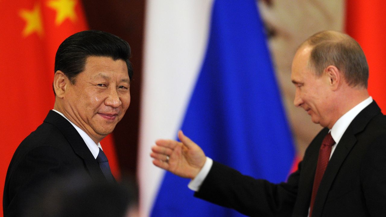 File photo of Russia's President Vladimir Putin greeting Chinese President Xi Jinping in March.