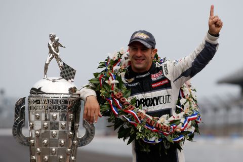Indianapolis 500 Champion Tony Kanaan of Brazil poses with the Borg Warner Trophy at the Indianapolis Motor Speedway's "yard of bricks" on Monday, May 27.